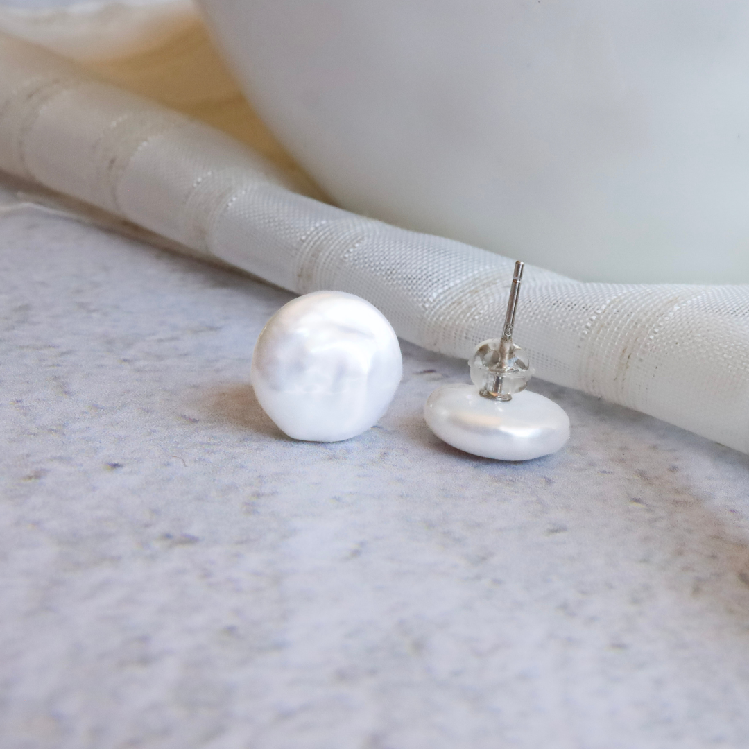 Freshwater Pearl Coin Earrings - Unique Luxury for the Modern Fashionista. Featuring lustrous freshwater pearls in a unique coin shape, these exclusive earrings add a touch of luxury to any outfit.